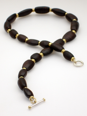 African blackwood and 18ct gold necklace.